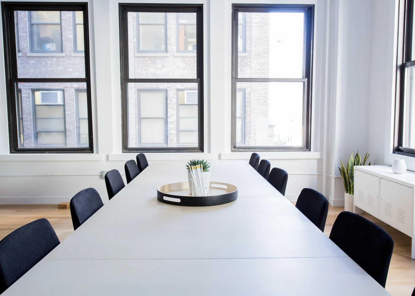 Bright professional meeting room with long conference table